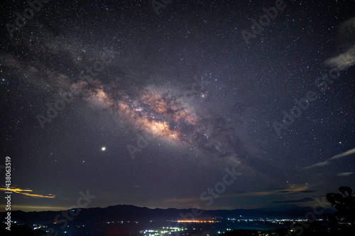 The beautiful Milky Way in the starry night over the landscape of the countryside of Thailand.