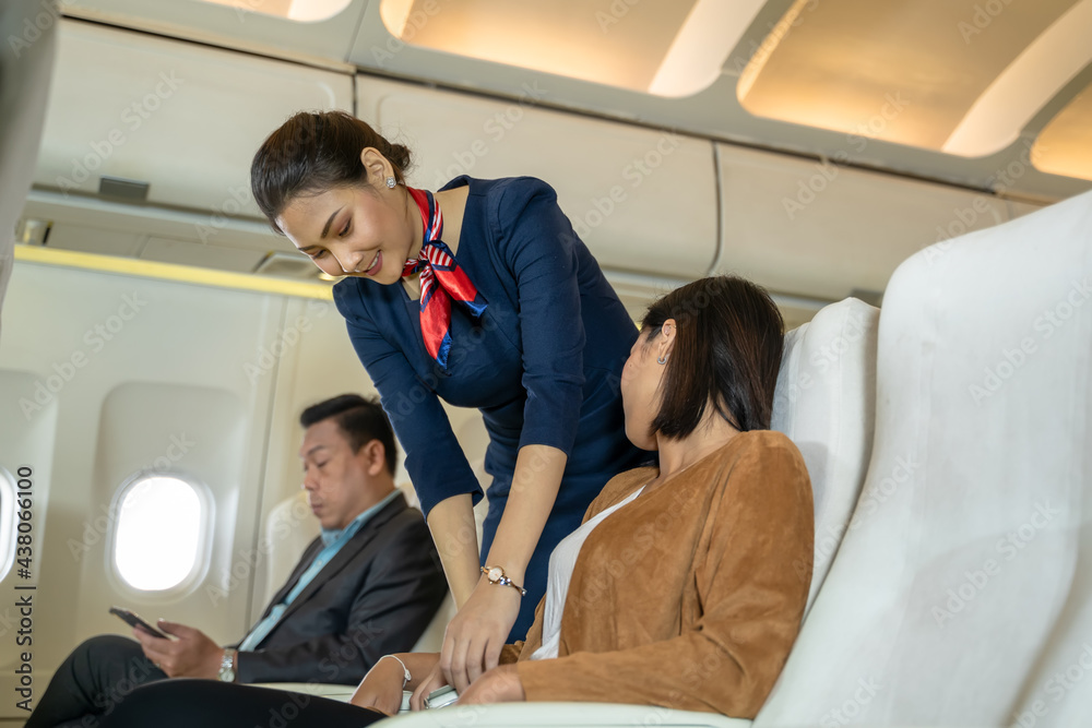 Cabin crew or air hostess seat belt for a safe trip of passengers in planes,Airline transportation and tourism concept. Cabin crew or air hostess seat belt for a safe trip of passengers in planes,Airline transportation and tourism concept.
