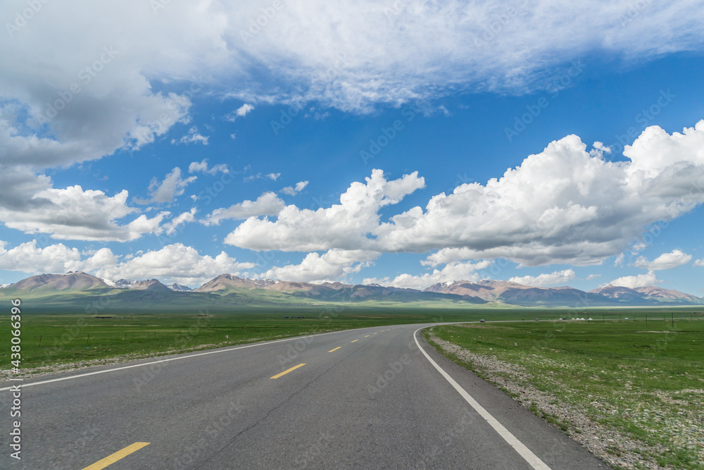 Highways with mountains and grasslands in Xinjiang, China in summer Highways with mountains and grasslands in Xinjiang, China in summer