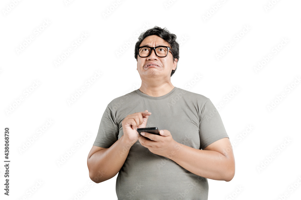 Asian man in eyeglasses with unhappy expression Asian man in eyeglasses with unhappy expression