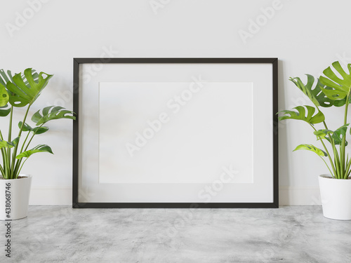 Fototapeta Naklejka Na Ścianę i Meble -  Black frame leaning on floor in interior mockup. Template of a picture framed on a wall 3D rendering