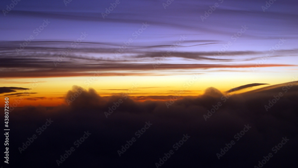 Colorful sunset seen from an airplane window.
Cloud silhouette photo taken kilometers high.