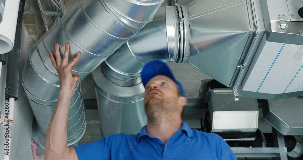 hvac services - worker install ducted system for ventilation and air conditioning with recuperation