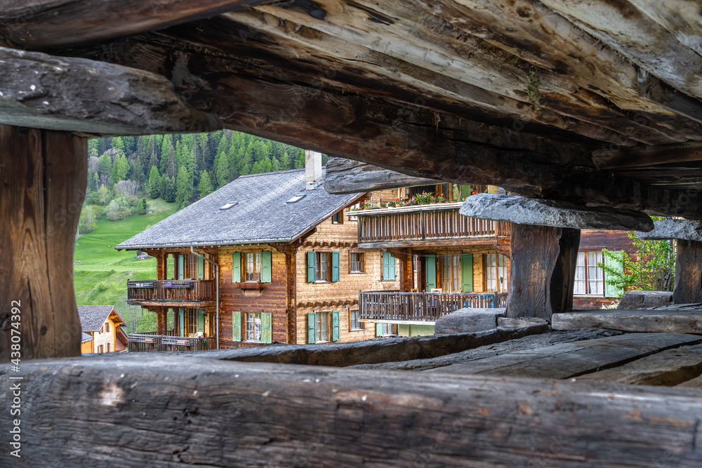 Traditional wooden houses in Evolene, a village in the valley of Herens in the French-speaking part of the canton of Valais in Switzerland. Traditional wooden houses in Evolene, a village in the valley of Herens in the French-speaking part of the canton of Valais in Switzerland.