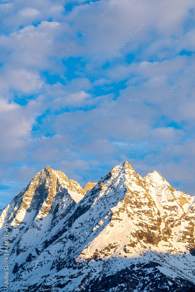 Snow covered mountain peaks of Dent de Veisivi and Denti de Perroc above Val Herens in Switzerland at sunset