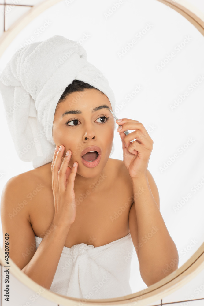 scared young african american woman with open mouth plucking eyebrows with tweezers in bathroom scared young african american woman with open mouth plucking eyebrows with tweezers in bathroom