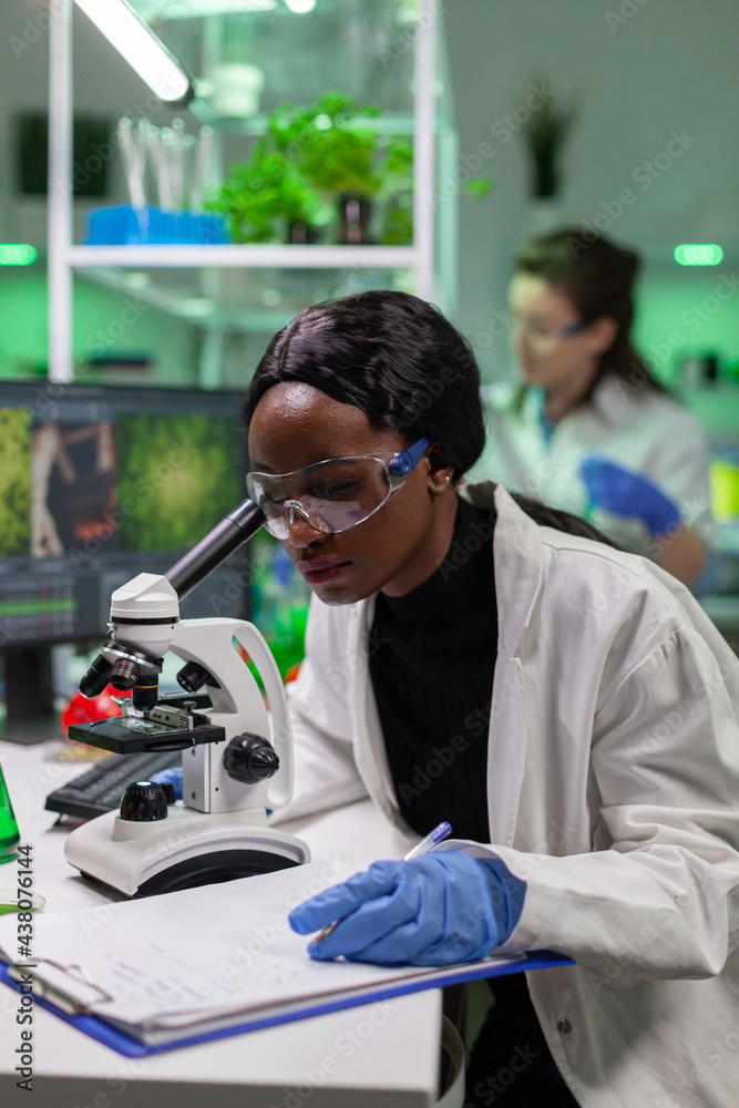 Biochemistry doctor examining chemical test using microscope for genetic researcher. Biologist specialist discovery organic gmo plants while working in microbiology food laboratory. Biochemistry doctor examining chemical test using microscope for genetic researcher. Biologist specialist discovery organic gmo plants while working in microbiology food laboratory.