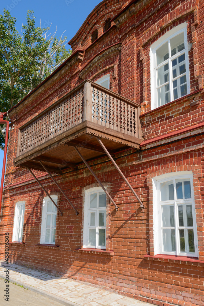 Wooden balcony in an old red brick house