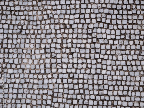 Old cobblestone blocks pavement texture background.