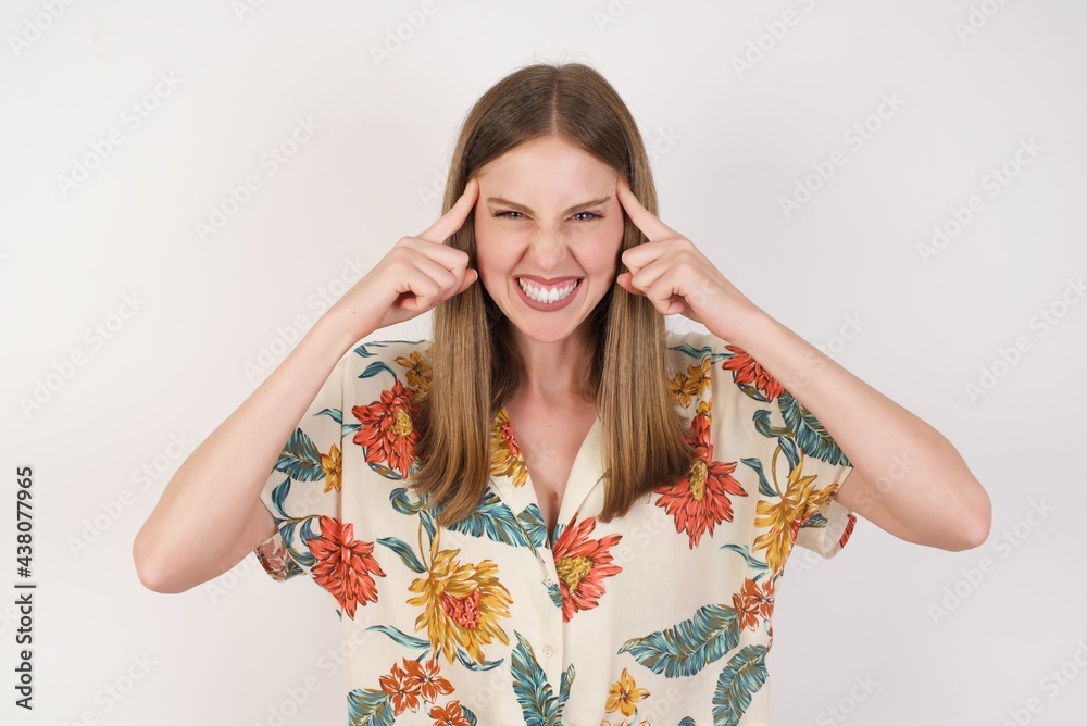 Young beautiful girl concentrating hard on an idea, with a serious look, thinking with both index fingers pointing to forehead eyes closed. Young beautiful girl concentrating hard on an idea, with a serious look, thinking with both index fingers pointing to forehead eyes closed.