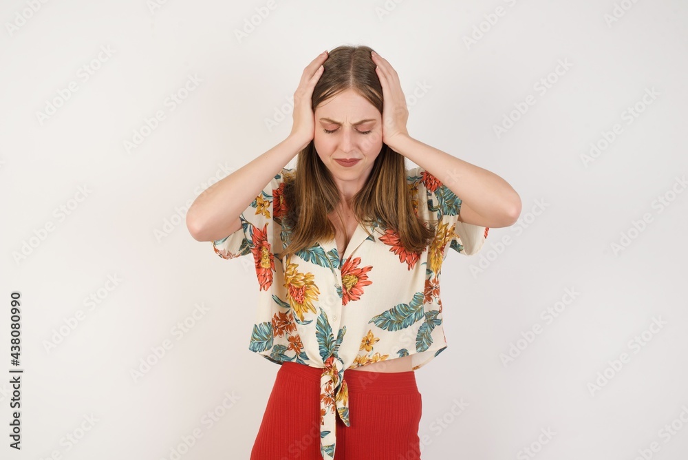 Young beautiful woman holding her head over isolated background suffering from headache desperate and stressed because pain and migraine. Hands on head.