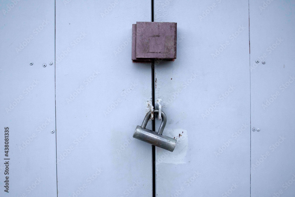 Iron lock on gray painted iron door, security gate shutter