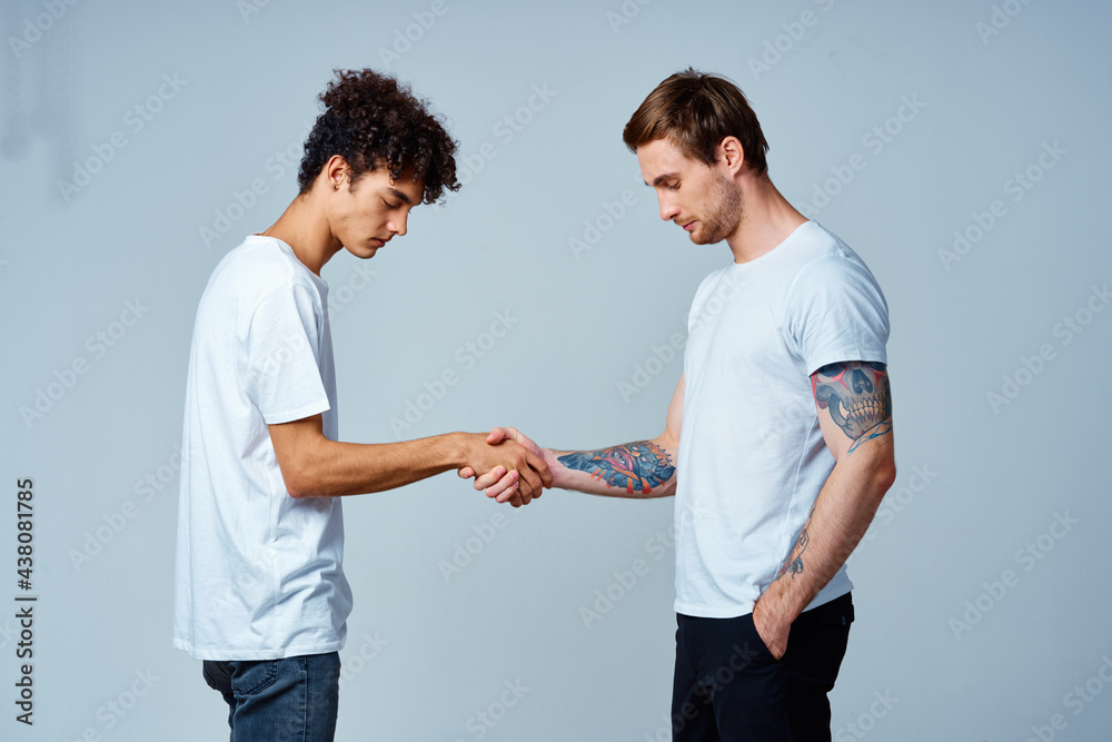 two men friendship shaking hands isolated background two men friendship shaking hands isolated background