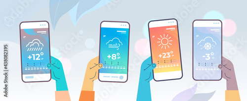 human hands holding smartphones with daily temperature mobile app weather forecasting and meteorology