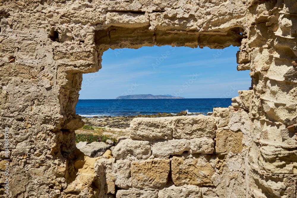 Levanzo Island of the Egadi archipelago in Sicilia seen from the ancient stones of the Tonnara di Trapani in ruins