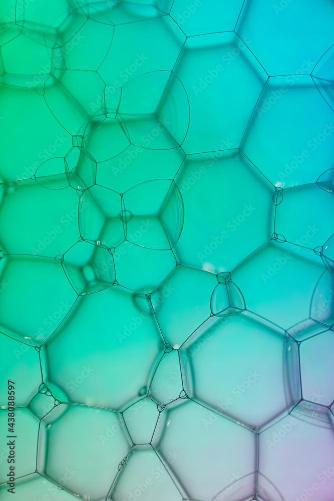 Fototapeta premium Extreme closeup of soap bubble patterns creating an art image with shadow effect caused by lighting and colour.