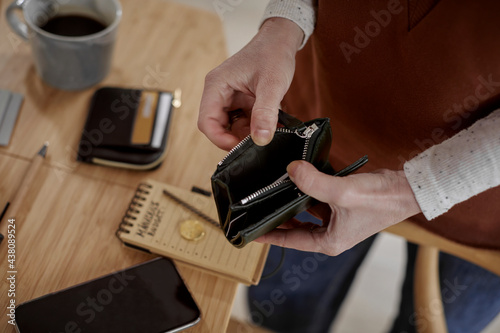 Man's hands holding wallet photo