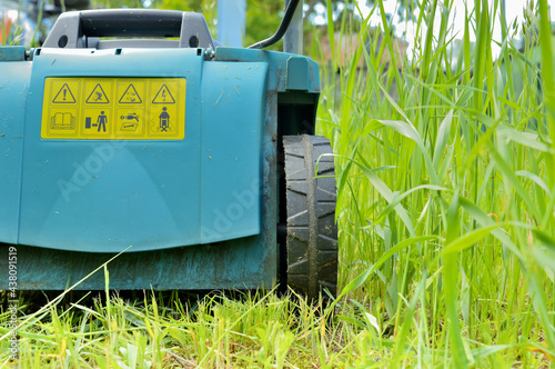 backside of electric lawn mower with safety and danger signs and icons photo