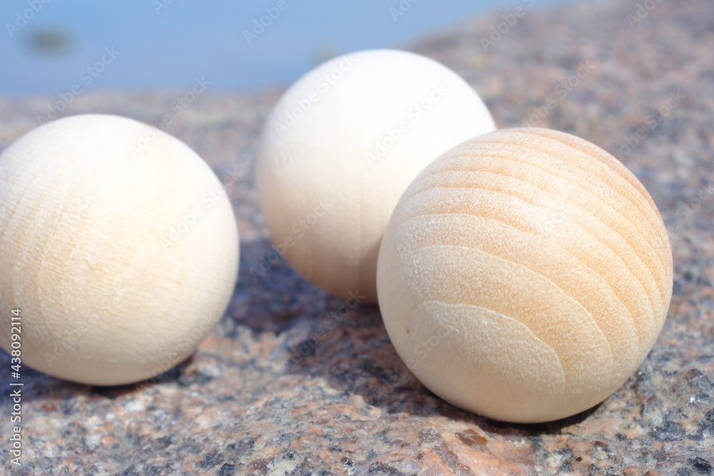 Wooden spheres on the rock, macro photography Wooden spheres on the rock, macro photography