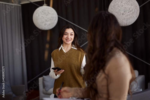 Wallpaper Mural Female coworkers talking at work Torontodigital.ca