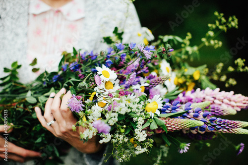 Hands holding bouquet of wildflowers photo