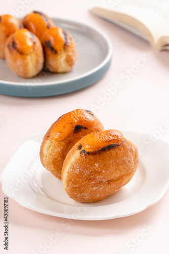 A bombolone or bomboloni is an Italian filled doughnut and is eaten as a snack food and dessert. This Bomboloni has many flavors like strawberry, chocolate, blueberry, etc.