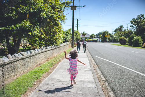 A girl Jumping on Waverley Street, Karamea, New Zealand