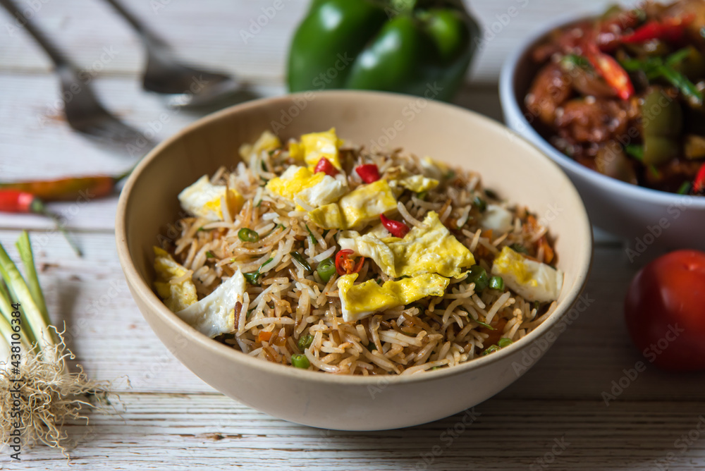 Chinese cuisine egg and vegetables fried rice in a bowl. Close up. Chinese cuisine egg and vegetables fried rice in a bowl. Close up.
