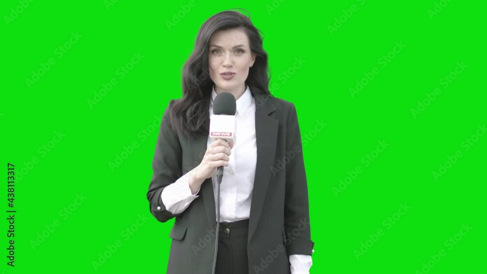 GREEN SCREEN CHROMA KEY Mid 30s Caucasian female TV news reporter in formal wear talking against green background. Shot outside on windy overcast day GREEN SCREEN CHROMA KEY Mid 30s Caucasian female TV news reporter in formal wear talking against green background. Shot outside on windy overcast day