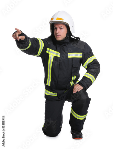 Full length portrait of firefighter in uniform and helmet on white background © New Africa