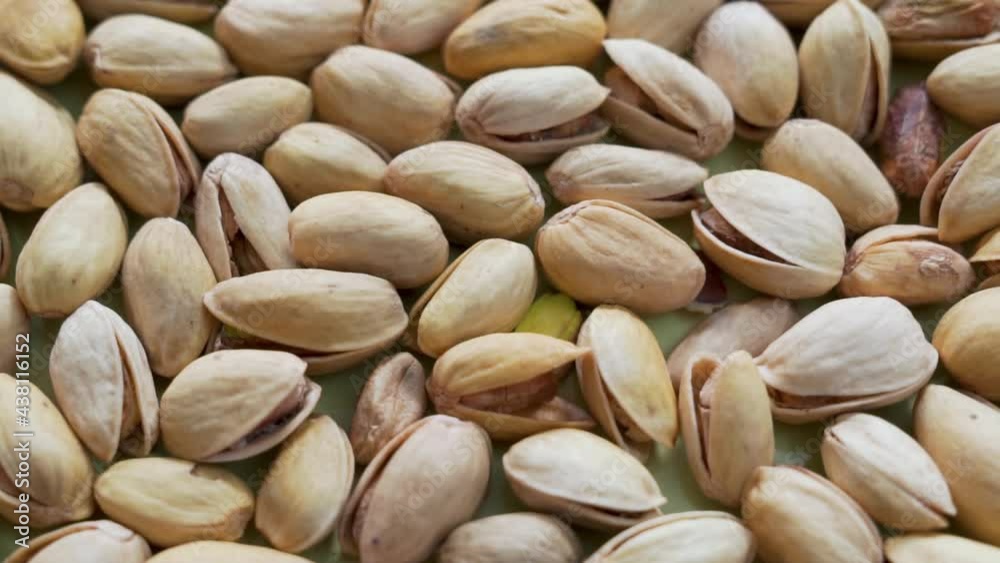 Salted Pistachios for Beer, Macro, Spin. Isolated Background of a Beer Snack of Salted Pistachio Nuts. Healthy Delicious Pistachios.