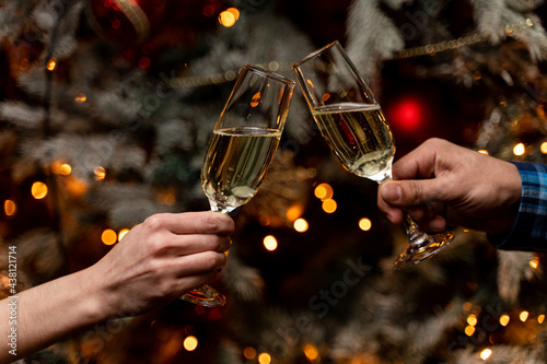 New year's eve, people clinking glasses of champagne, festive atmosphere