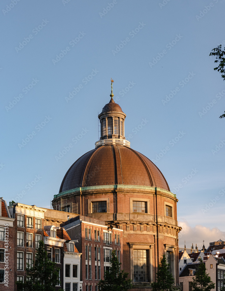 Fototapeta premium Historical buildings of Amsterdam in the sunset light.