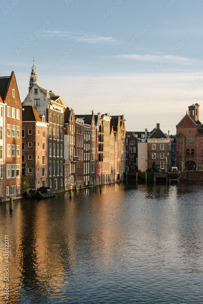 Historical buildings of Amsterdam in the sunset light.