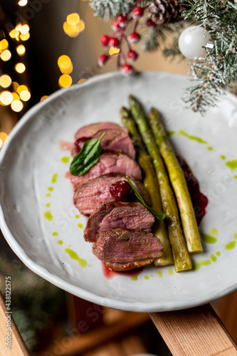 Kobe rare steak with roasted asparagus top view in winter surroundings photo