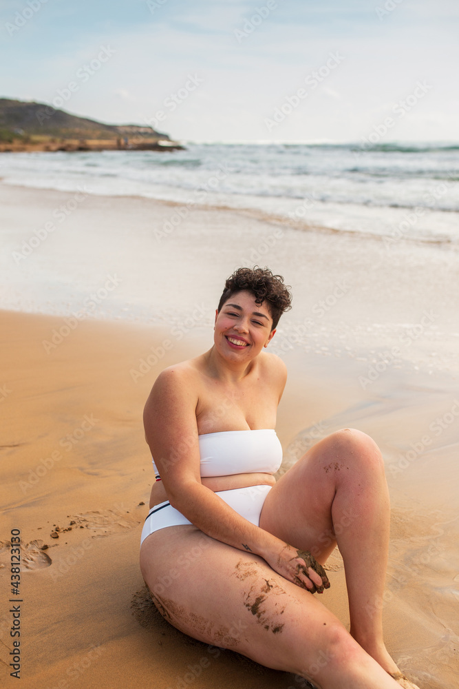 Lady sitting on sandy coast near sea Lady sitting on sandy coast near sea