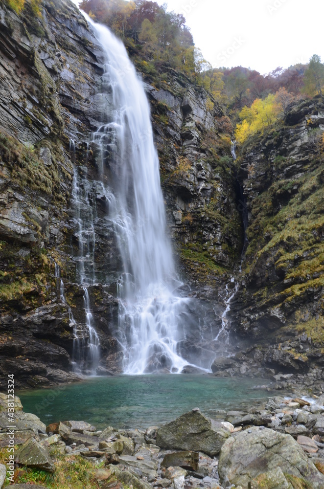Waterfall at Ticino Valle Maggia, Maggiatal, Switzerland. At beautiful landscape scenery with colorful leaves, gras