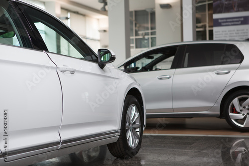 Cropped shot of unrecognizable new cars parked at automobile dealership salon © Ihor