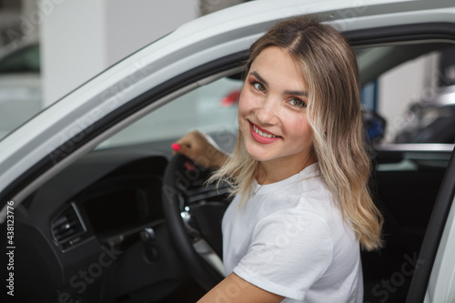 Close up of a cheerful female driver smiling to the camera