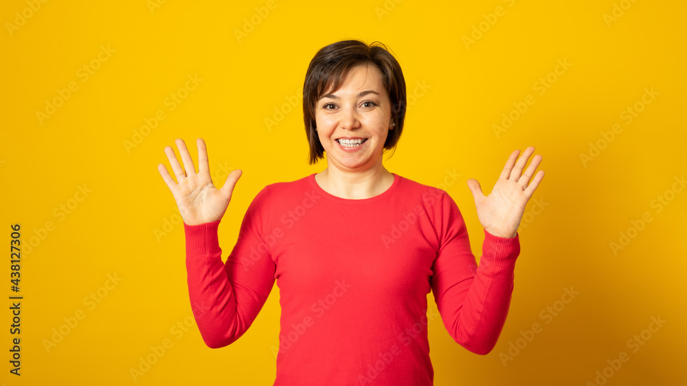 Emotional pretty woman on a yellow background. Beautiful positive woman. Emotional pretty woman on a yellow background. Beautiful positive woman.