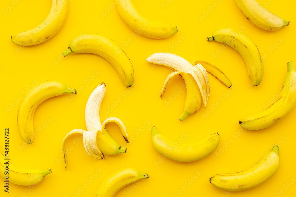 Whole and peeled bananas flay lay. Fruits pattern. Top view