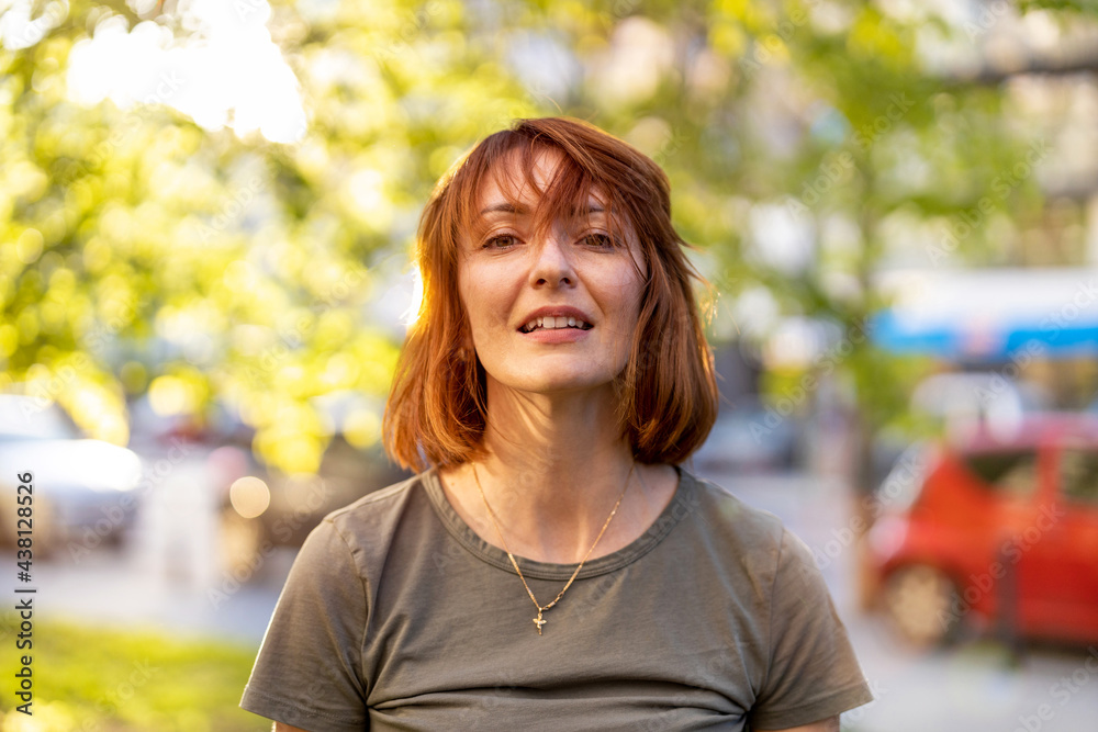 Portrait of smiling redheaded woman in the city
Portrait of smiling redheaded woman in the city