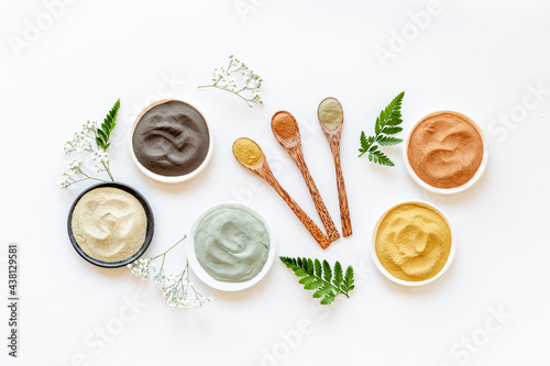 Cosmetic clay powder and mask in bowls, top view