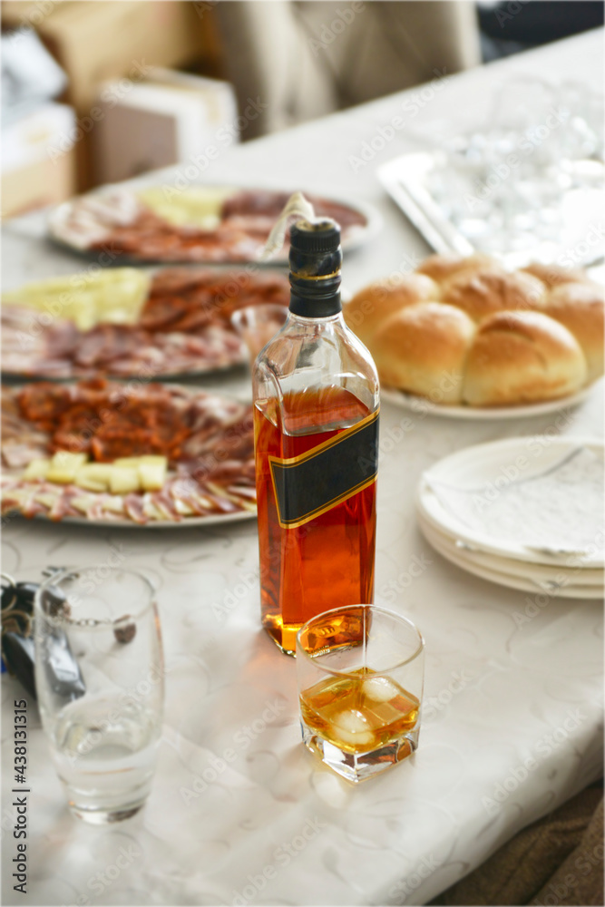 Glass and bottle of whiskey on the table Glass and bottle of whiskey on the table