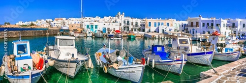 Greece travel. Cyclades, Paros island. Charming fishing village Naoussa. view of old port with boats and street taverns by the sea. may 2021
