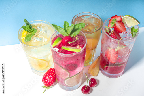 Iced refreshing drink. Bar and caffee beverage menu background. Set of various cold summer cocktails - peach tea, lemonade, mojito, cherry mocktail, with frruits on colorful bright blue background