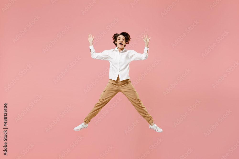 Full length overjoyed young successful employee business woman 20s corporate lawyer in classic formal white shirt work in office jump high with outstretched hands isolated on pastel pink background