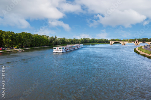 White cruise ship on the Rhone River near the Saint-Benezet Bridge. Avignon, France photo