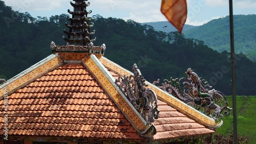 Static shot of ornate roof of Giac Nguyen Buddhist Temple, Vietnam photo