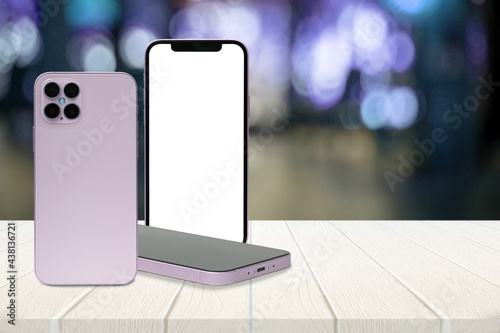 Three smartphones on white wooden table white blank screen